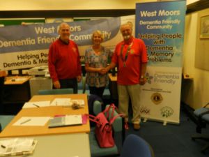 Lions Club members wih a West Moors Dementia Friends representative making use of their banners